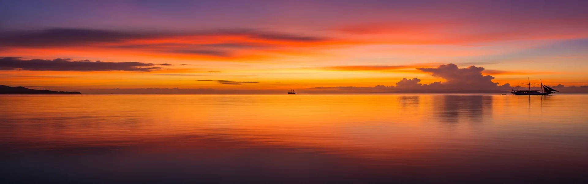 Spectacular golden sunset over Komodo waters during evening cruise